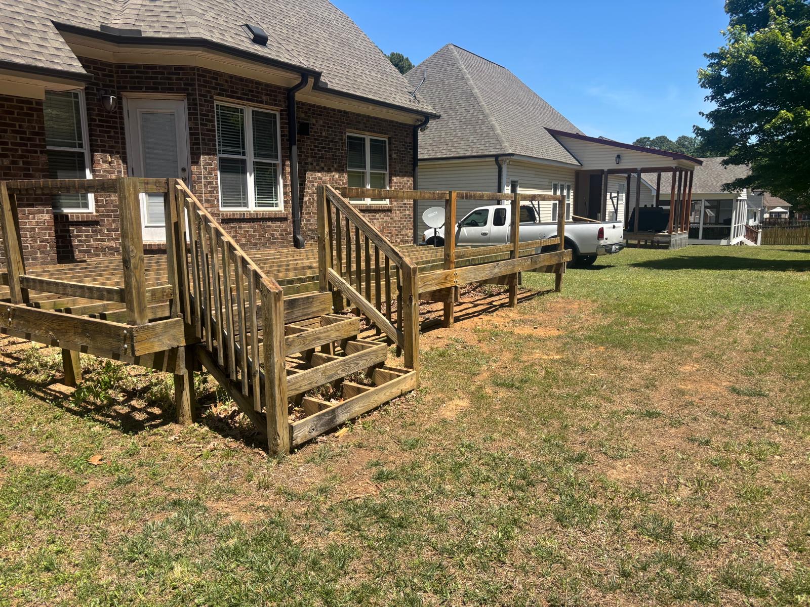 Same deck after refinishing with fresh tan stain on railings and floor